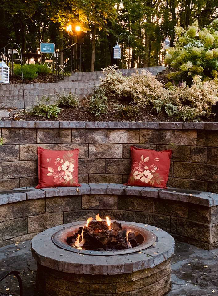 Two pillows accent the sitting area next to the patio fire pit
